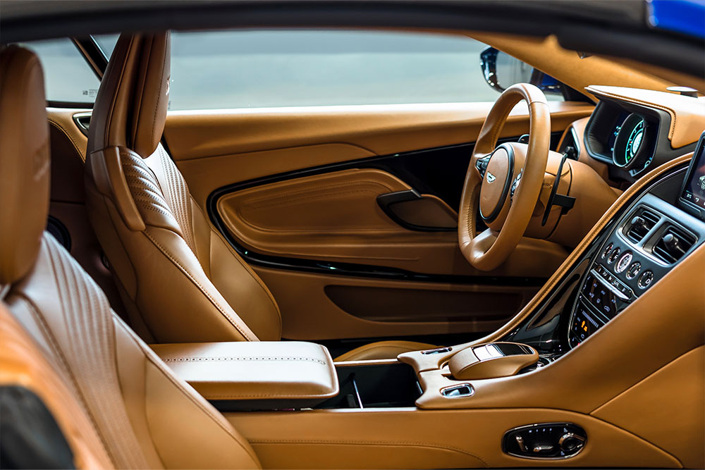 Photo of a sports car's beige leather interior.